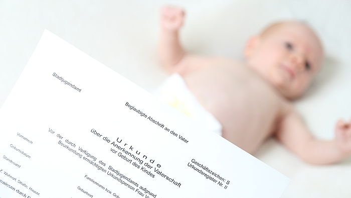 Schriftstueck mit einem Saugling im Hintergrund